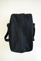 Black canvas duffle bag with 24 seven club logo on a patch