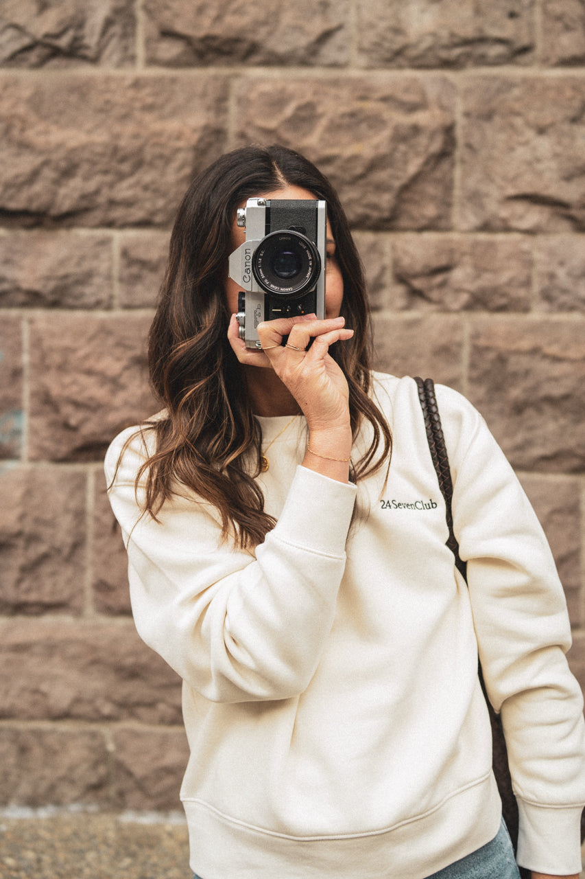 Women wearing cream embroidered 24 seven club crewneck sweatshirt