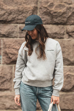 Entrepreneur wearing a 24 seven club heather grey crewneck sweatshirt and hat